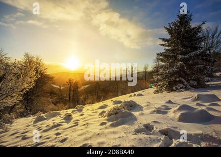 Sonne steigt über Hügeln mit Schnee bedeckt im Winter Natur Stockfoto