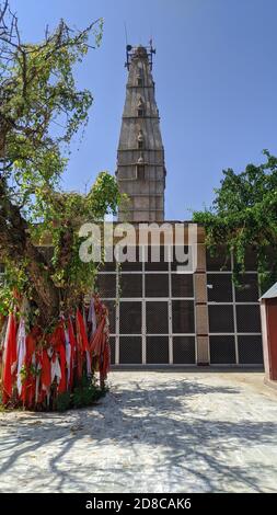 21. Oktober 2020 : Reengus, Jaipur, Indien / Alter hindu-Tempel mit roten Fahnen und grünen Bäumen. Stockfoto