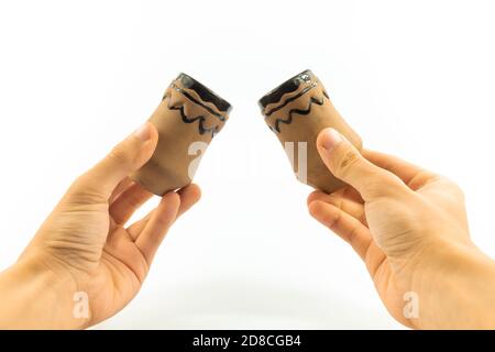 Alte Steingut in den Händen eines Mannes, antik auf einem weißen isolierten Hintergrund Stockfoto