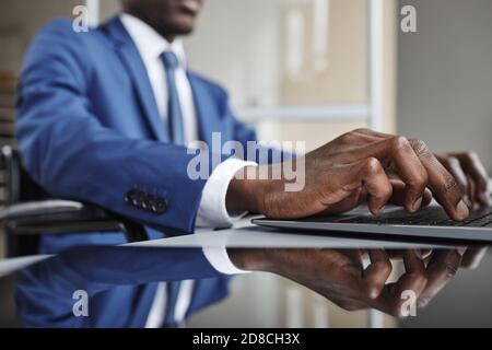 Nahaufnahme von afrikanischen Geschäftsmann tippen auf der Tastatur auf Laptop bei Die Tabelle Stockfoto