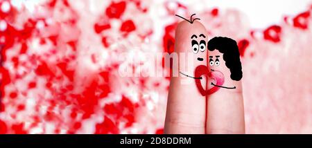 Finger mit bemalten Gesichtern und Haare mit ein Herz in den Händen, das Konzept der Liebhaber, leer für den Valentinstag Stockfoto