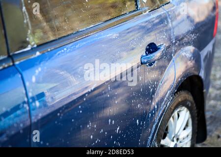 Hintertür des Autos mit Schaumstoff während des Waschens, Nahaufnahme Stockfoto