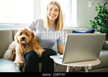 Frau mit seinem Golden Labradoodle Hund zu Hause Stockfoto