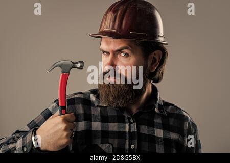 Bauarbeiter tragen Schutzhelm. Tragen Sicherheitsausrüstung. Supervisor auf der Baustelle. Seriöse und selbstbewusste Militärangehörige. Brutalen Hipster Mann. Mann in Hut. Ingenieur verwenden Hammer. Stockfoto