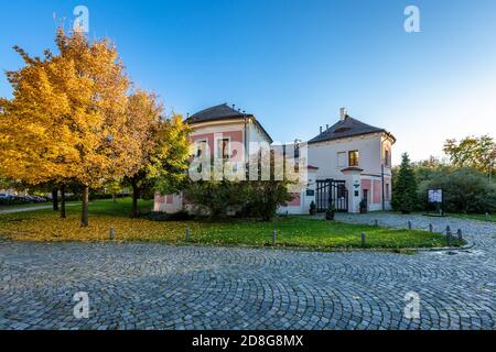 Prag / Tschechische Republik - Oktober 29 2020: Blick auf Chodov Fotress steht in einem Park mit grünem Gras, gelben und orangen Ahornbäumen. Sonniger Abend. Stockfoto