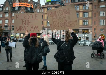 Kopenhagen, Dänemark. Oktober 2020. Polen in Dänemark und Unterstützer protestieren gegen das strenge Abtreibungsgesetz in Polen. Demonstranten halten Plakate mit Parolen hoch und tragen das rote Blitzbild, das zu einem Symbol der Proteste geworden ist. Stockfoto