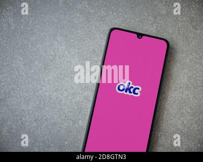 LOD, Israel - 8. Juli 2020: OkCupid App Launch Screen mit Logo auf dem Display eines schwarzen Smartphone auf Keramik Stein Hintergrund. Draufsicht flach Stockfoto