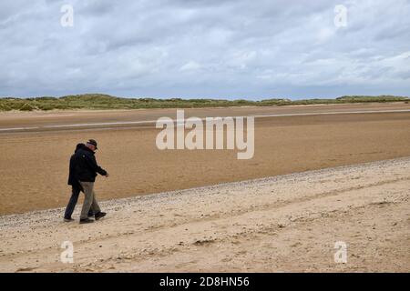 Paar zu Fuß auf holkham Strand, Norden norfolk, england, großbritannien Stockfoto