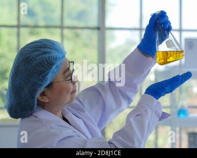 Eine leitende Wissenschaftlerin, die wissenschaftliche Forschung durchführt, um den Rückstand zu sehen oder von der Verbindung die Forschung im Labor zu verunreinigen. Zur Vorbereitung Stockfoto