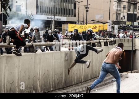 Beirut, Libanon, 30. Oktober 2020. Eine kleine Gruppe von Männern aus Tripolis und Beirut, die eine Autobahnbarriere aufschlugen, um Polizeiknüppeln zu entkommen, prallte mit libanesischen Sicherheitskräften des Innern zusammen, als die panislamische Gruppe Hizb Ut Tahrir versuchte, vor der französischen Botschaft zu marschieren, um gegen die antiislamische Haltung des Präsidenten Emmanuel Macron zu protestieren. Emotionen liefen hoch, als es fühlte, dass Prophet Mohammed während seines Geburtstags missachtet wird. Kredit: Elizabeth Fitt/Alamy Live Nachrichten Stockfoto