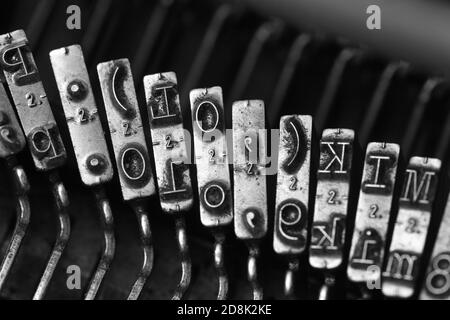 Details von Schreibmaschinenhämmern mit verschiedenen Buchstaben, Zahlen und Symbolen Stockfoto