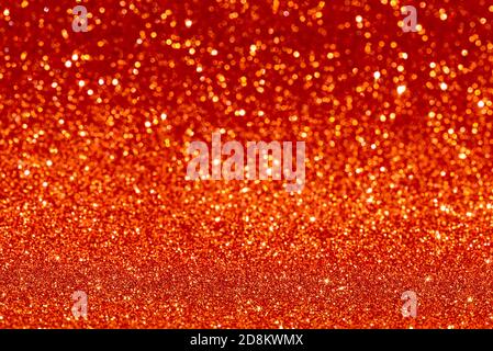 Golden rot Glitzer funkelt Textur Weihnachten abstrakten Hintergrund. Defokussed orange Farbe leuchtet Hintergrund. Stockfoto