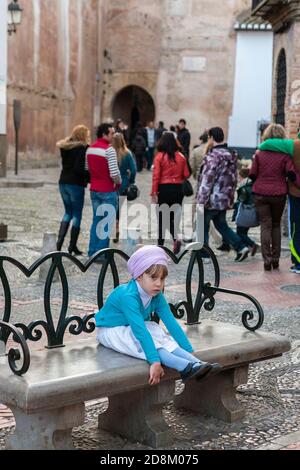 Das kleine Mädchen sieht während des Andalusia Day auf der Plaza Larga, El Albaicín, Granada, Andalusien, Spanien gelangweilt aus Stockfoto