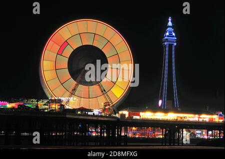 Die vielen Farben des Blackpool Tower und das Riesenrad Nachts während der jährlichen Beleuchtung Stockfoto
