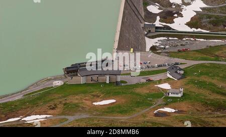 Silvretta Hochalpenstraße, Österreich - 06/23/2019: Luftaufnahme Silvretta Stausee und Staudamm mit Parkplatz, Restaurant und Hotel im Frühsommer. Stockfoto