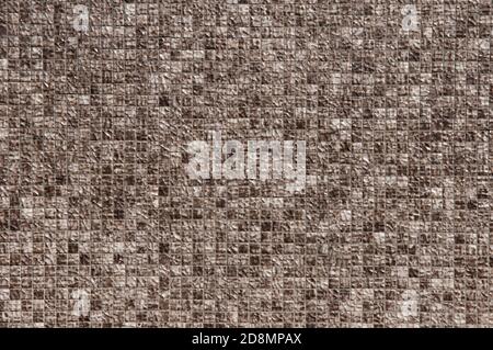 Eine Nahaufnahme von Melierten Braun und Weiß Mosaic Tiling An der Außenwand EINES Gebäudes Stockfoto