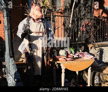 Ottawa, Kanada. Oktober 2020. Grauenhafte Halloween tableau auf Preston Straße in Little Italy Nachbarschaft. Mit einem Metzger mit einem Schweinekopf neben einem Tisch mit menschlichen Resten zum Verkauf Stockfoto