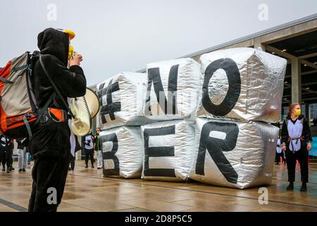 Protestor im Pinguin-Kostüm mit Megaphon am '#NOBER'-Schild als Klimaaktivist protestieren gegen die Eröffnung des Flughafens Berlin Brandenburg (ber). Stockfoto