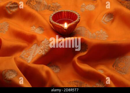 diwali diya oder Tonlampe über Seidentuch gelegt. Stockfoto