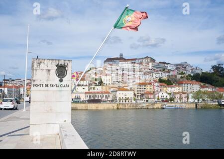Coimbra Stadtansicht mit portugiesischer Flagge von der Santa Clara Brücke, Portugal Stockfoto