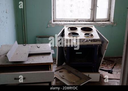 Zerstörter Elektroherd in der Küche. Ein Zimmer in einem verlassenen Haus in der Tschernobyl-Sperrzone. Stockfoto