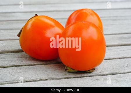 Drei Hachiya Orange Kaki Früchte Stockfoto