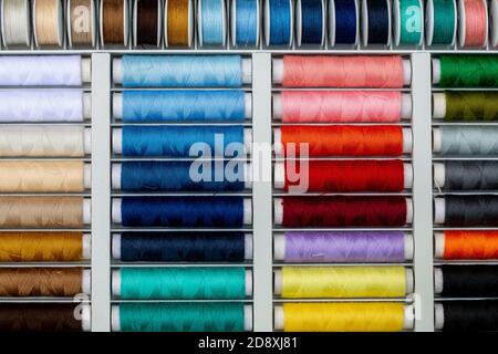 Ein Satz von Fäden in verschiedenen Farben. Mehrfarbige Fäden zum Nähen und Nadelarbeiten. Kleine Fadenrollen in verschiedenen Farben. Stockfoto