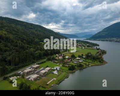 Luftaufnahme am Ossiacher See in Kärnten, Österreich von Alt-Ossiach an einem bewölkten Sommertag. Stockfoto