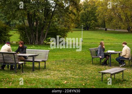 Die Leute reden und spielen Schach auf Letna Park in Herbst 2020 auf Prag 6 während Quarantänezeit wegen Ausbruch von COVID-19 als Winter ist starti Stockfoto