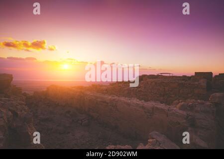 Schönen lila Sonnenaufgang über der Festung Masada. Ruinen von König Palast des Herodes in der Wüste Juda Stockfoto