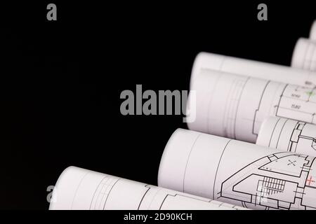Architekturprojekt, Zeichnungen auf dunklem Hintergrund. Rollen von Projektzeichnungen Stockfoto