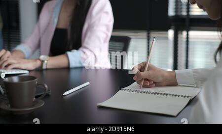 Eine kurze Aufnahme asiatischer Geschäftsleute, die in modernen Büros zusammenarbeiten. Stockfoto