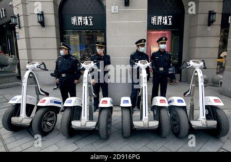 Wuhan, China. November 2020. Chinesische Sicherheitskräfte überwachen große Menschenmengen, die eine Einkaufsstraße besuchen, während die Erholung vom Covid-19 am Sonntag, den 1. November 2020 in Wuhan, der Hauptstadt der Provinz Hubei, fortgesetzt wird. Wuhan erlebt, wie viele Städte in ganz China, eine Belebung des Geschäfts und des "täglichen Lebens", nachdem das Coronavirus die ganze Stadt in den Sperrungshaft gebracht hat. Foto von Stephen Shaver/UPI Kredit: UPI/Alamy Live Nachrichten Stockfoto