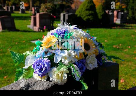 Blumen auf einem Grabstein Stockfoto