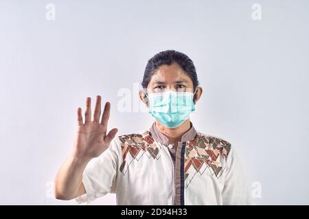 Potrait von asiatischen Mann zeigt Geste stoppen. Asiatischer Mann trägt chirurgische Maske gegen ansteckende Viren zu schützen und vor allen Verschmutzungen zu schützen Stockfoto