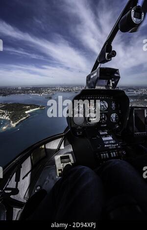 Vertical interior of a helicopter cockpit flying over a Sydney cityscape Stockfoto