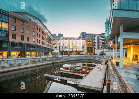 Oslo, Norwegen. Ansicht von mehrstöckigen Wohnhäusern im Aker Brygge Bezirk im Sommerabend. Berühmter Und Beliebter Ort. Pier Jetty Mit Booten. Stockfoto