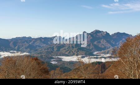Schöne Panorama-Luftaufnahme der Garfagnana von San Pellegrino in Alpe, mit Herbstfarben und niedrigen Wolken in den Tälern unten, Italien Stockfoto