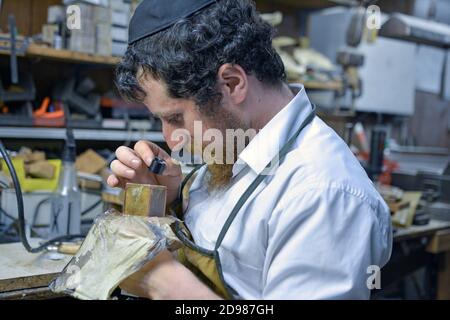 In seiner Werkstatt stellt ein Rabbiner und Meister ein Mylacteries (Tefillin) her, das von orthodoxen Juden während der morgendlichen Parayer benutzt wird. In Brooklyn, New York C Stockfoto