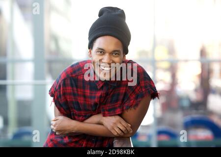Portrait von coolen jungen schwarzen Mode Mann lehnt und lächelt Stockfoto