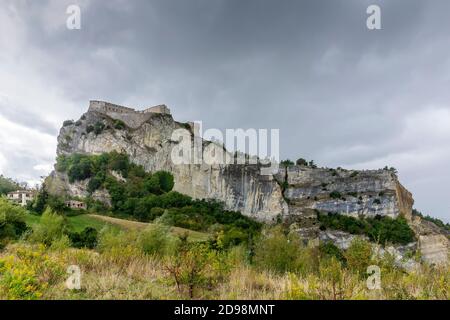 Die imposante Festung von San Leo, Emilia Romagna, Italien, unter einem stürmischen Himmel mit Regenwolken Stockfoto