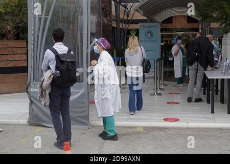 Athen, Griechenland - 3. November 2020: Ärzte mit Gesichtsmasken unterstützen Menschen am Eingang des Krankenhauses während der Coronavirus-Pandemie covid-19. Stockfoto