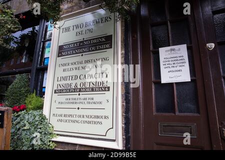 Windsor, Großbritannien. November 2020. Ein Schild, das vor dem Haus der zwei Brauer angebracht ist, verweist auf die sozialen Distanzierungsrichtlinien COVID-19. Die schwer zu bekämpfenden lokalen Unternehmen bereiten sich auf Englands zweite nationale Sperre vor, um die Ausbreitung des Coronavirus zu bekämpfen, das am 5. November beginnen und vier Wochen dauern wird. Kredit: Mark Kerrison/Alamy Live Nachrichten Stockfoto