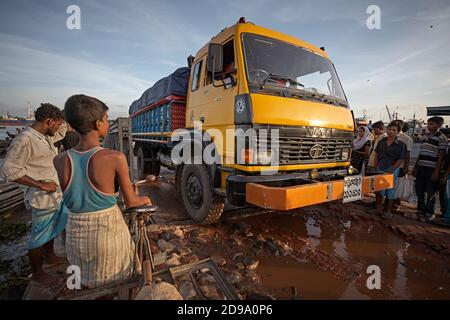 Chittagong, Bangladesh, Juli 2009 - EIN Lastwagen wartet auf eine Brücke auf einer verfallenen Straße, die mit Wasser und Schlamm gefüllt ist. Stockfoto