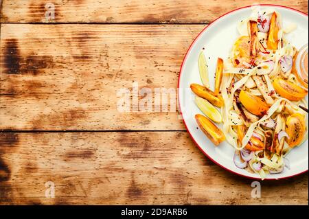 Orientalisches Essen, Salat mit Nudeln und Kaki auf altem Holztisch Stockfoto