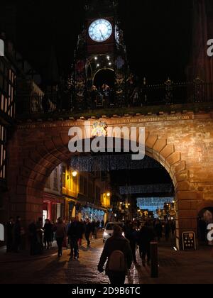 Spätnächtliche Weihnachtseinkäufer unter der Eastgate-Uhr in Chester, England Stockfoto