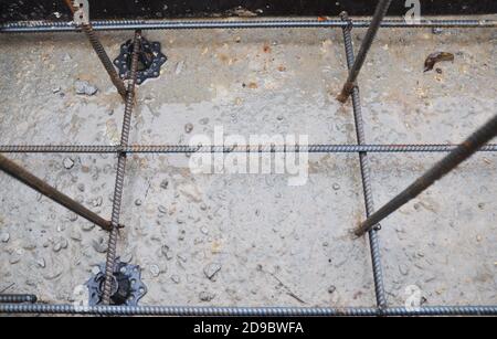 Nahaufnahme einer Betonfundament-Verstärkung mit Eisenstangen, Geflecht aus Stahlstangen. Stockfoto