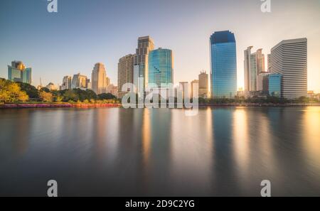 See im öffentlichen Park unter Wolkenkratzern bei Sunrise. Benjakiti Park in Bangkok, Thailand Stockfoto