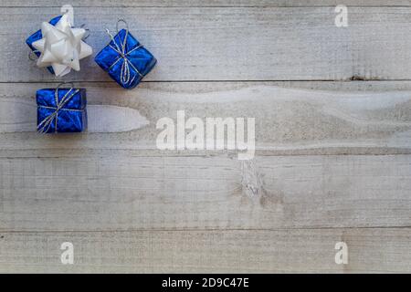 Drei blaue Geschenke weiße Schleife für festliche Feiertage Hanukkah Konzept Grauer Hintergrund flach Lay-Copy-Platz Stockfoto