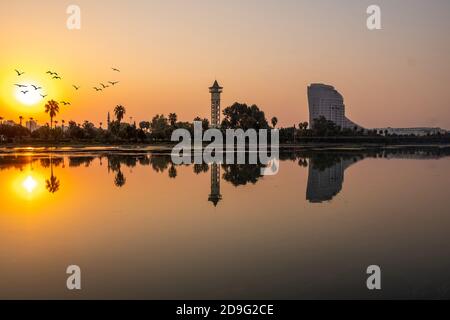 Adana, Türkei, Oktober 2020: Besinnung, Bäume und Bauen auf der orangen Flusslandschaft. Stockfoto